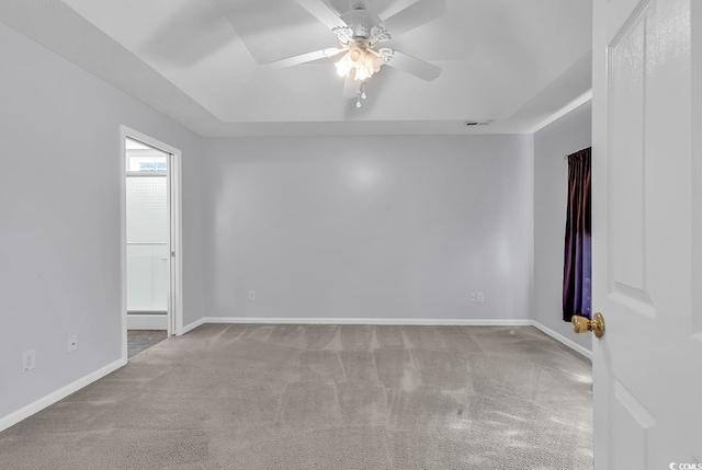 carpeted spare room with baseboards and ceiling fan