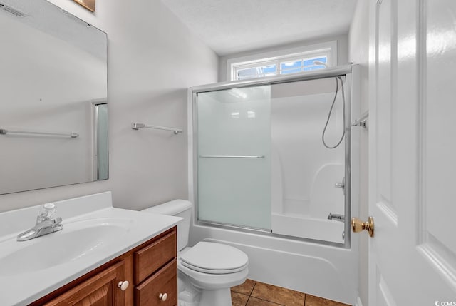 bathroom with combined bath / shower with glass door, vanity, tile patterned flooring, toilet, and visible vents