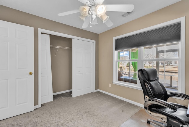 carpeted office with visible vents, ceiling fan, and baseboards