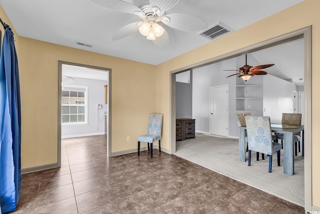 carpeted dining area featuring visible vents, baseboards, and a ceiling fan