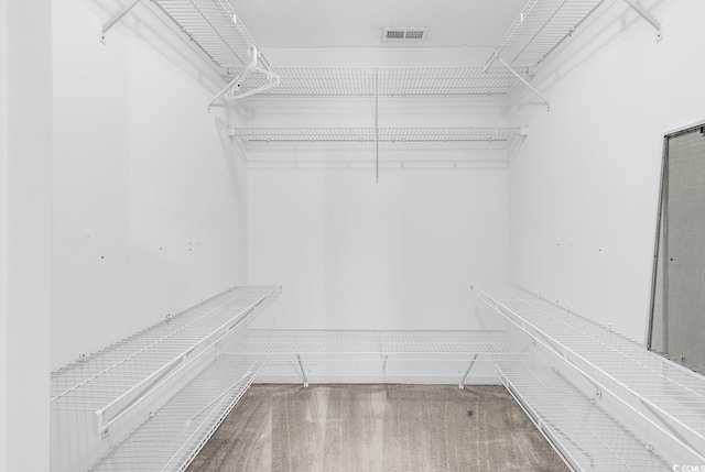 spacious closet featuring visible vents