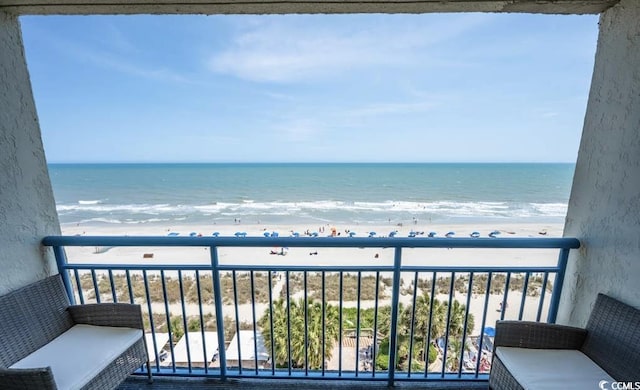 balcony featuring a water view and a beach view