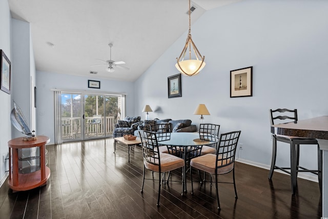 dining room with visible vents, baseboards, ceiling fan, dark wood-style floors, and high vaulted ceiling