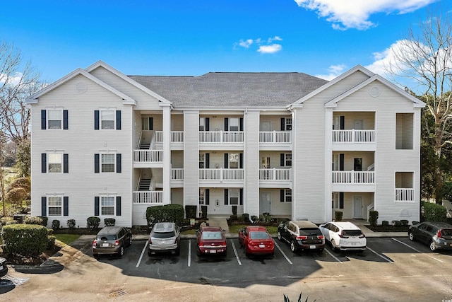 view of building exterior with uncovered parking