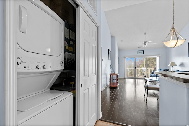 washroom featuring visible vents, wood finished floors, stacked washer / dryer, ceiling fan, and laundry area