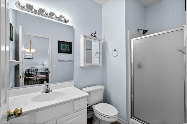 full bathroom with vanity, toilet, and a shower stall