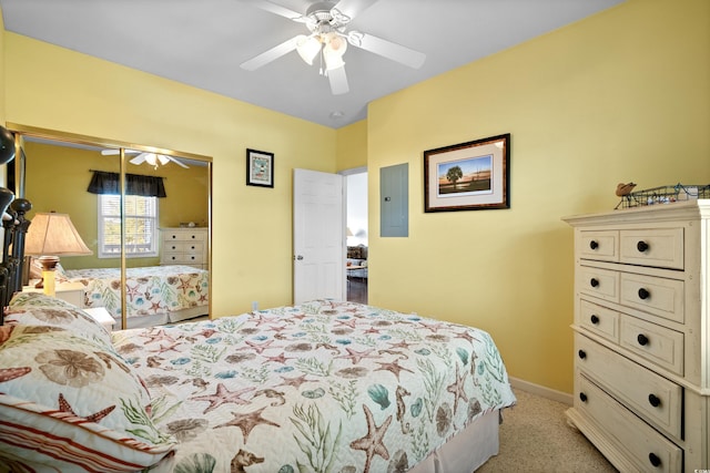 bedroom with baseboards, ceiling fan, light colored carpet, electric panel, and a closet