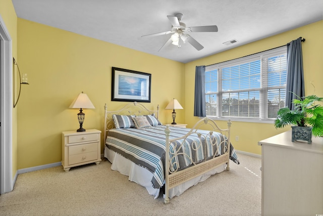 bedroom featuring visible vents, light carpet, baseboards, and a ceiling fan