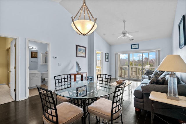 dining room with visible vents, baseboards, high vaulted ceiling, a ceiling fan, and dark wood-style flooring