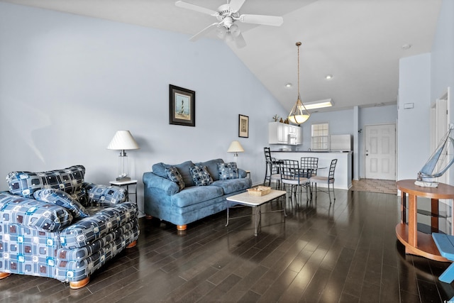 living area with lofted ceiling, ceiling fan, and wood finished floors