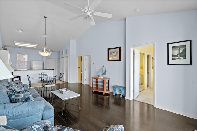 living room with baseboards, high vaulted ceiling, ceiling fan, and wood finished floors