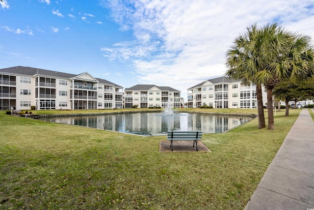 view of community featuring a yard and a water view