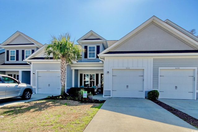 622 Lorenzo Dr Unit 622, North Myrtle Beach, SC 29582 - view of front of home with concrete driveway, board and batten siding, a front yard, and a garage