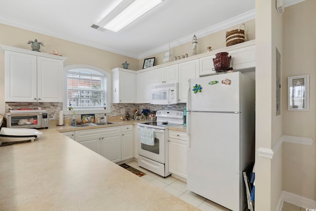 4142 Hibiscus Dr Unit 104, Little River, SC 29566 - kitchen with white appliances, decorative backsplash, white cabinets, light countertops, and crown molding