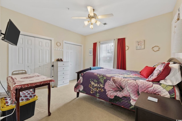 4142 Hibiscus Dr Unit 104, Little River, SC 29566 - carpeted bedroom with two closets and a ceiling fan