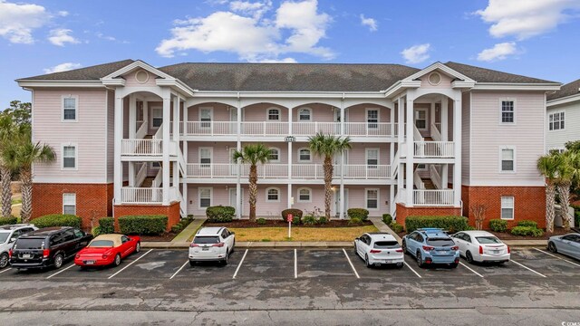 4142 Hibiscus Dr Unit 104, Little River, SC 29566 - view of building exterior with uncovered parking