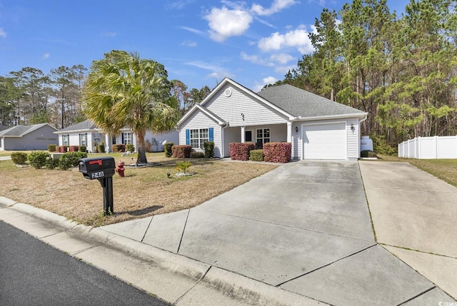 single story home with an attached garage, fence, a front yard, and concrete driveway