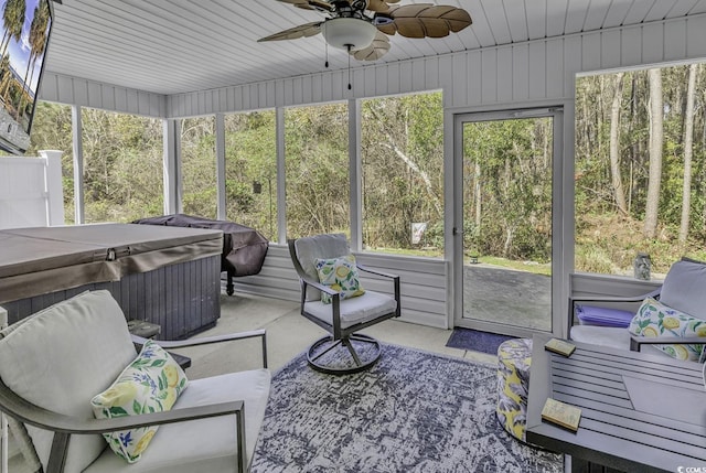 sunroom with ceiling fan and a hot tub