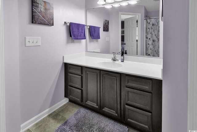 full bathroom with baseboards, vanity, and tile patterned floors