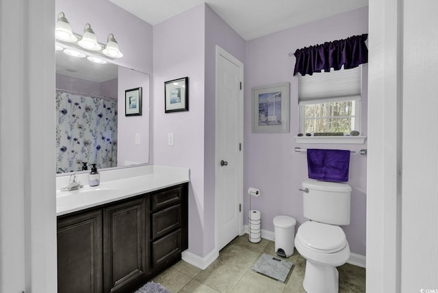 full bathroom featuring baseboards, vanity, tile patterned flooring, and toilet