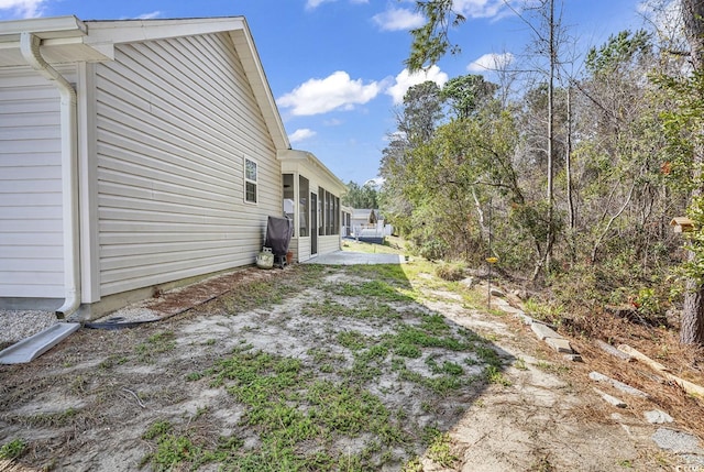 view of yard with a sunroom