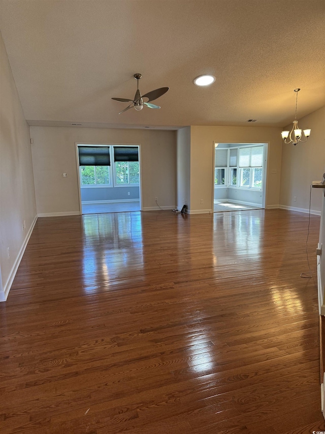 1205 Woodruff Ct, Conway, SC 29526 - unfurnished living room with plenty of natural light, dark wood-style flooring, a chandelier, ceiling fan, and a textured ceiling