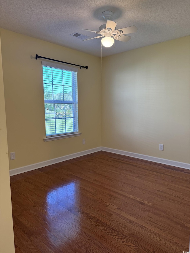 1205 Woodruff Ct, Conway, SC 29526 - unfurnished room with dark wood-type flooring, a textured ceiling, ceiling fan, and baseboards