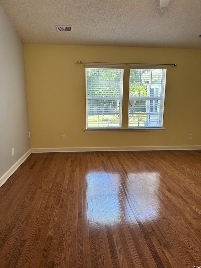 1205 Woodruff Ct, Conway, SC 29526 - spare room with wood finished floors, baseboards, and a textured ceiling