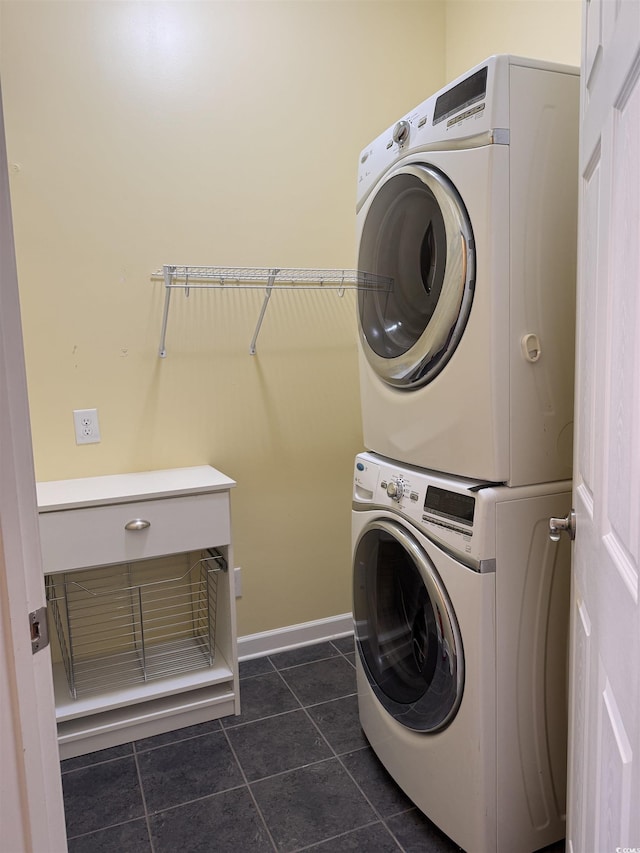 1205 Woodruff Ct, Conway, SC 29526 - laundry area featuring stacked washer / drying machine, dark tile patterned flooring, and baseboards