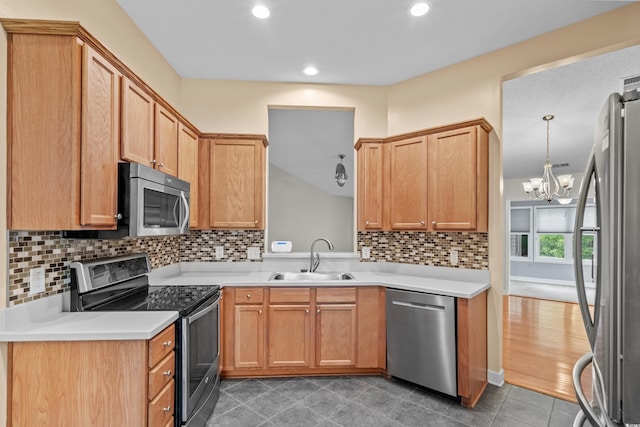 1205 Woodruff Ct, Conway, SC 29526 - kitchen with stainless steel appliances, light countertops, a chandelier, recessed lighting, and tasteful backsplash