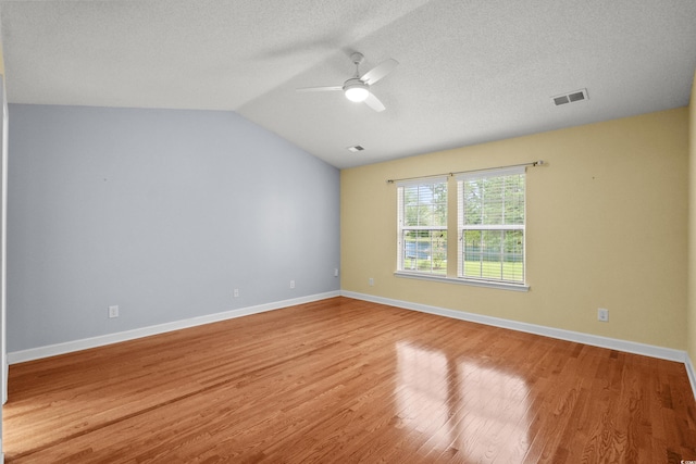 1205 Woodruff Ct, Conway, SC 29526 - empty room featuring ceiling fan, light wood-type flooring, lofted ceiling, and a textured ceiling