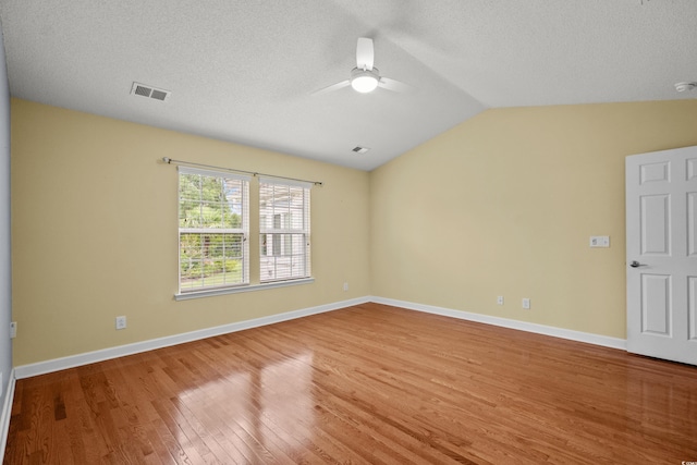 1205 Woodruff Ct, Conway, SC 29526 - unfurnished room with wood finished floors, a ceiling fan, lofted ceiling, and a textured ceiling