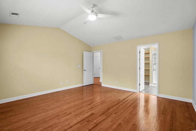 1205 Woodruff Ct, Conway, SC 29526 - unfurnished bedroom featuring light wood-style flooring, lofted ceiling, a ceiling fan, and a walk in closet