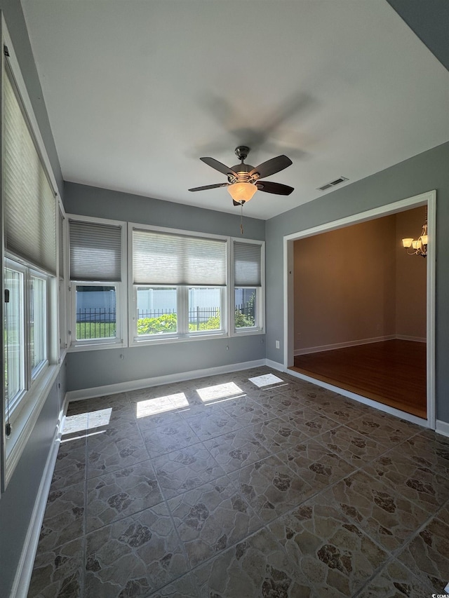 1205 Woodruff Ct, Conway, SC 29526 - empty room with stone flooring, a chandelier, ceiling fan, and baseboards