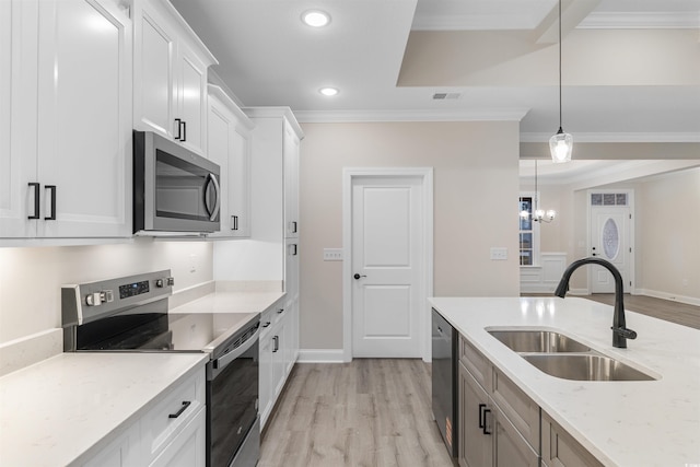 3329 Hughes Gasque Rd, Aynor, SC 29511 - kitchen with appliances with stainless steel finishes, crown molding, light wood-style flooring, recessed lighting, and light stone counters