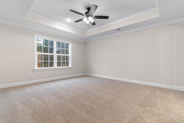 3329 Hughes Gasque Rd, Aynor, SC 29511 - spare room featuring a tray ceiling, ornamental molding, a ceiling fan, and light colored carpet