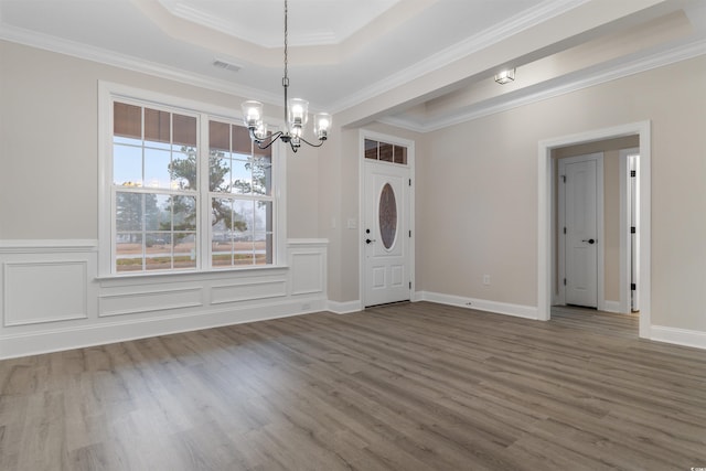 3329 Hughes Gasque Rd, Aynor, SC 29511 - foyer entrance featuring a chandelier, wood finished floors, a tray ceiling, and crown molding