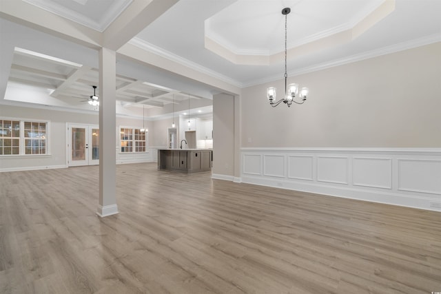 3329 Hughes Gasque Rd, Aynor, SC 29511 - unfurnished living room featuring a chandelier, a ceiling fan, light wood finished floors, coffered ceiling, and ornamental molding