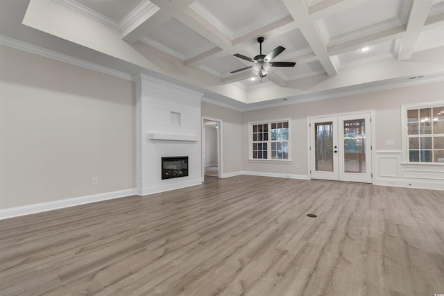 3329 Hughes Gasque Rd, Aynor, SC 29511 - unfurnished living room with plenty of natural light, ceiling fan, beamed ceiling, light wood-type flooring, and french doors