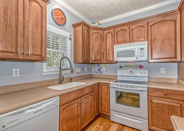 6001-1527 S Kings Hwy, Myrtle Beach, SC 29575 - kitchen with white appliances, brown cabinetry, a sink, light countertops, and crown molding