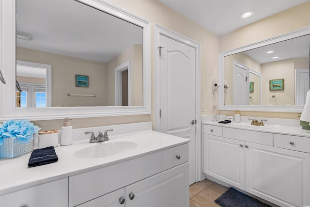 bathroom with a sink, tile patterned floors, recessed lighting, and two vanities