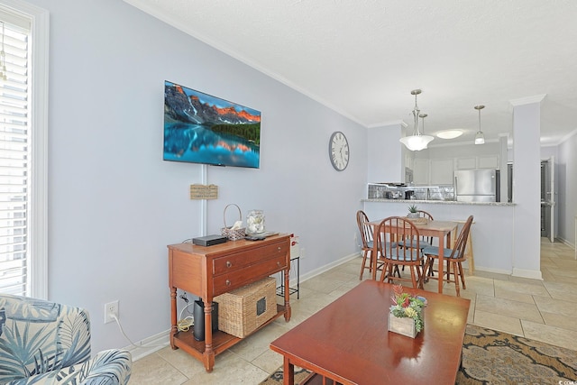 living area with baseboards and ornamental molding