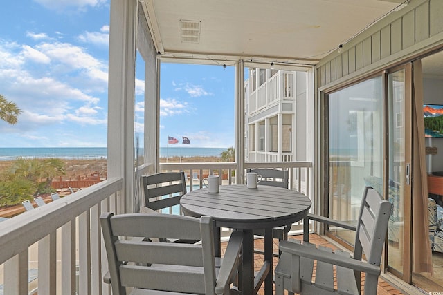 exterior space with visible vents, a view of the beach, and a water view