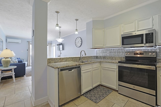 kitchen with crown molding, light stone countertops, a wall mounted air conditioner, appliances with stainless steel finishes, and a textured ceiling