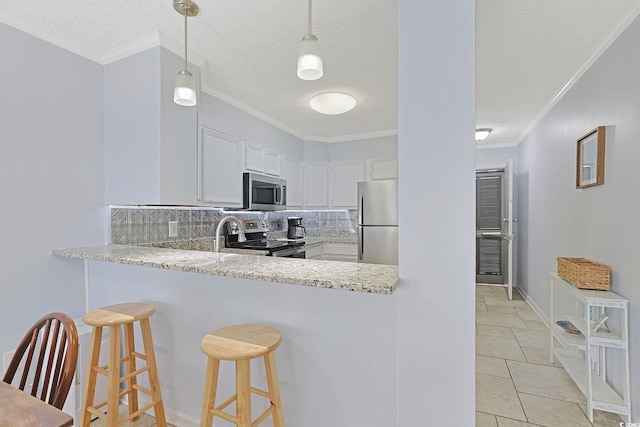 kitchen featuring tasteful backsplash, white cabinetry, stainless steel appliances, and crown molding
