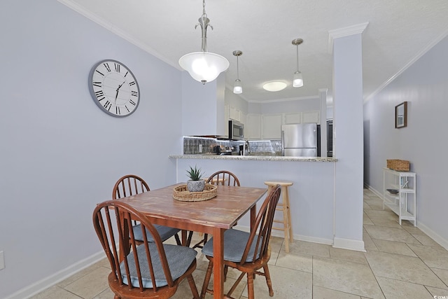 dining space featuring baseboards and crown molding