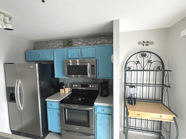5905 S Kings Hwy Unit 1116, Myrtle Beach, SC 29575 - kitchen with backsplash, light countertops, blue cabinets, and appliances with stainless steel finishes