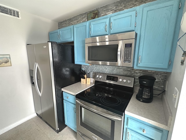 5905 S Kings Hwy Unit 1116, Myrtle Beach, SC 29575 - kitchen featuring visible vents, blue cabinetry, stainless steel appliances, light countertops, and decorative backsplash