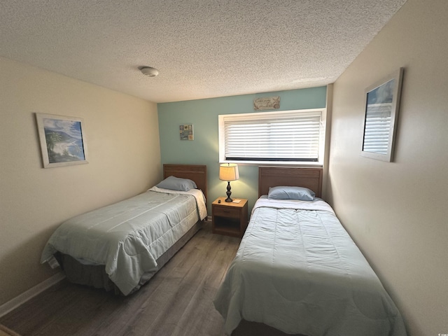 5905 S Kings Hwy Unit 1116, Myrtle Beach, SC 29575 - bedroom featuring baseboards, a textured ceiling, and wood finished floors