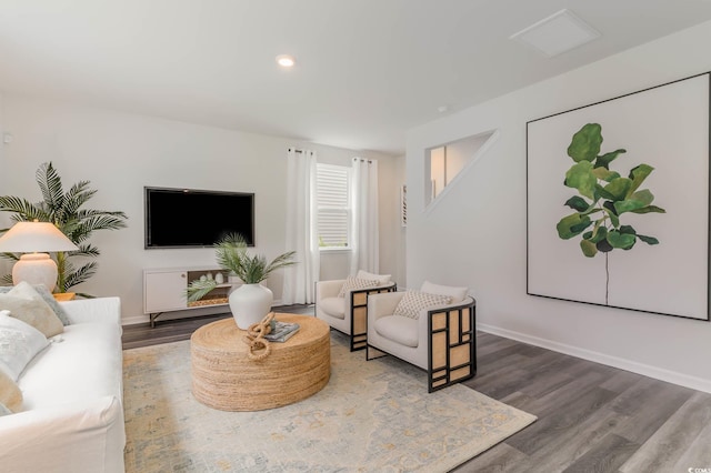 living room featuring wood finished floors, baseboards, and recessed lighting